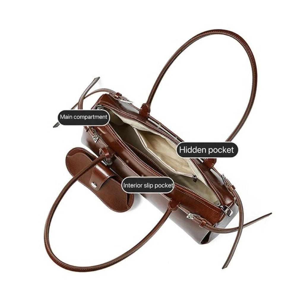 Brown leather handbag with labeled main compartment, hidden pocket, and interior slip pocket