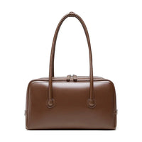 Brown leather handbag with double handles on white background