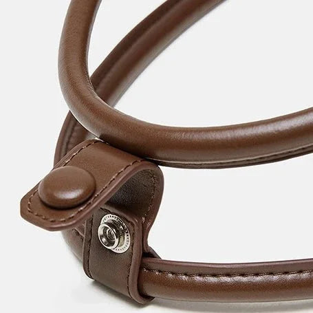 Brown leather bag handle with metal snap fastener on white background