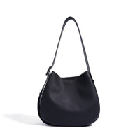 Black leather shoulder bag with pebbled texture on white background