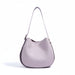 Light purple leather shoulder bag with adjustable strap on white background