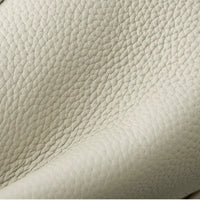 Close-up of textured cream leather upholstery with natural grain pattern