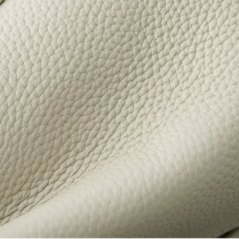 Close-up of textured cream leather upholstery with natural grain pattern