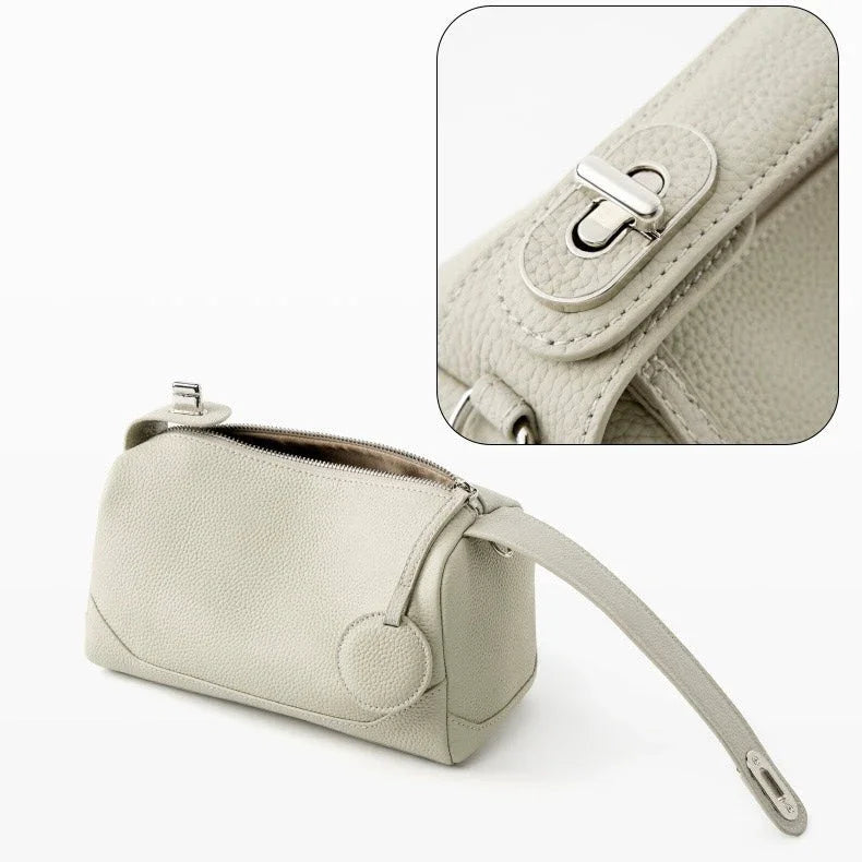 Beige leather handbag with silver hardware and textured finish, close-up of buckle detail