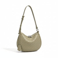 Woven leather shoulder bag in sage green with adjustable strap and silver clasp, product photo