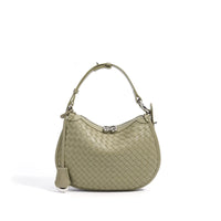 Sage green woven leather shoulder bag with silver hardware on a white background