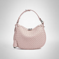 Light pink woven leather handbag with top handle and silver clasp on white background