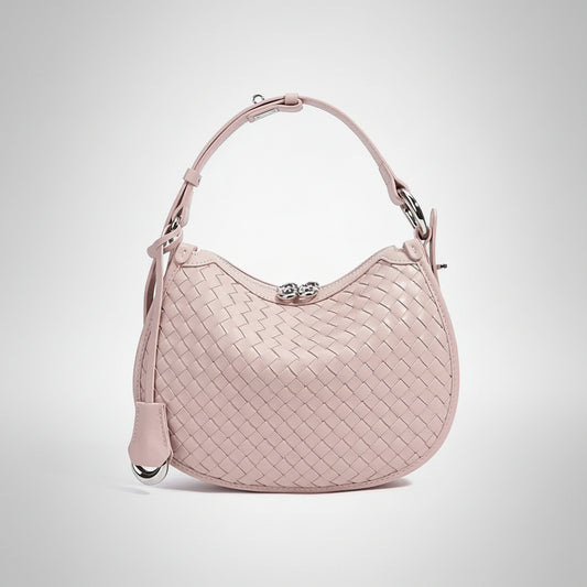 Light pink woven leather handbag with top handle and silver clasp on white background