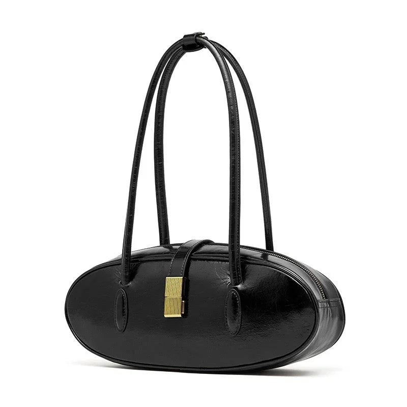Black oval leather handbag with double straps and gold clasp on white background
