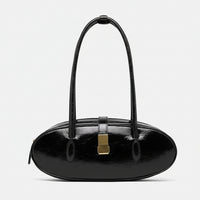 Black oval leather handbag with gold clasp and double shoulder straps on white background