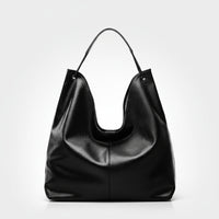 Black leather hobo bag with single handle on white background