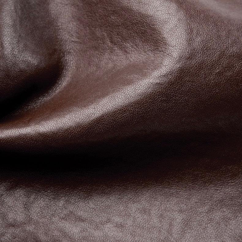 Close-up of smooth brown leather texture with subtle natural grain detail