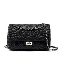 Black quilted leather shoulder bag with floral pattern and silver chain strap