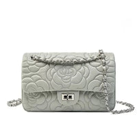 Gray quilted leather shoulder bag with floral stitching and silver chain strap