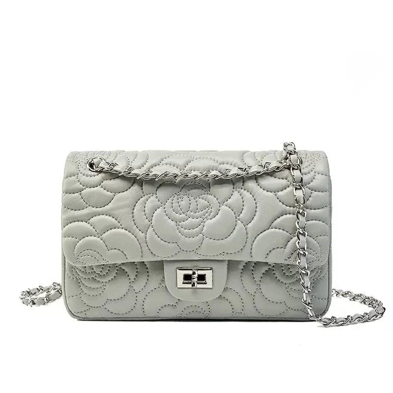 Gray quilted leather shoulder bag with floral stitching and silver chain strap