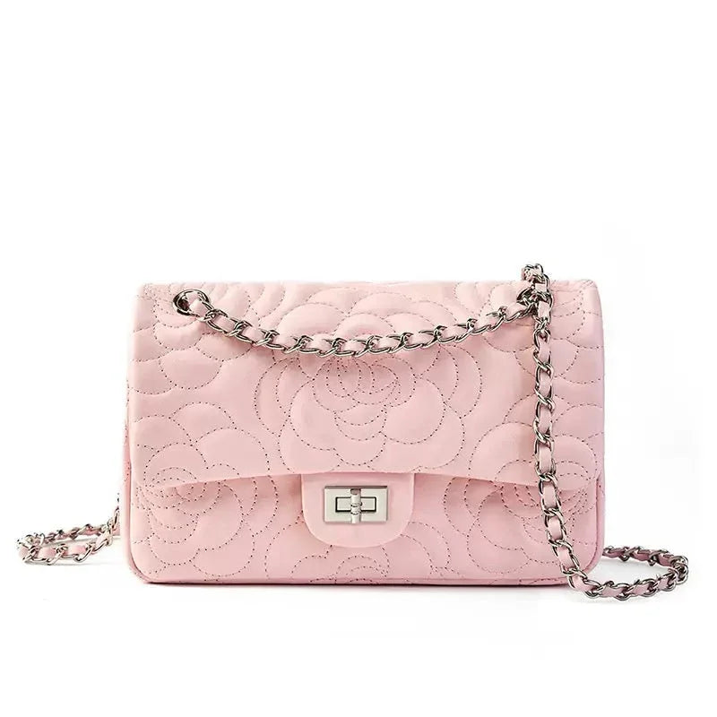 Light pink quilted shoulder bag with floral pattern and silver chain strap