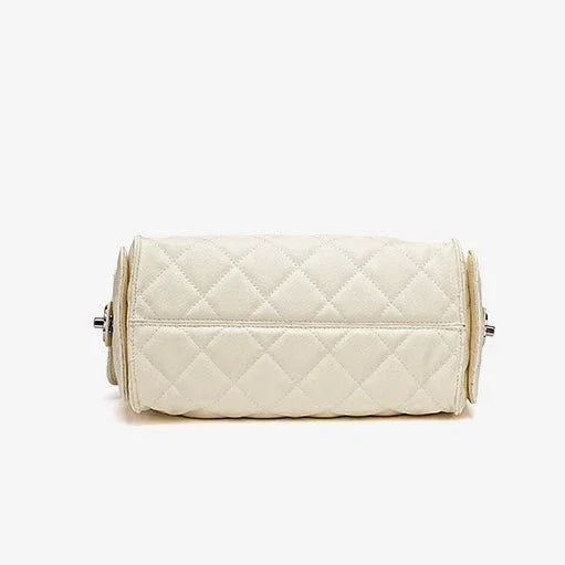 Quilted cream leather handbag with diamond pattern on a plain white background