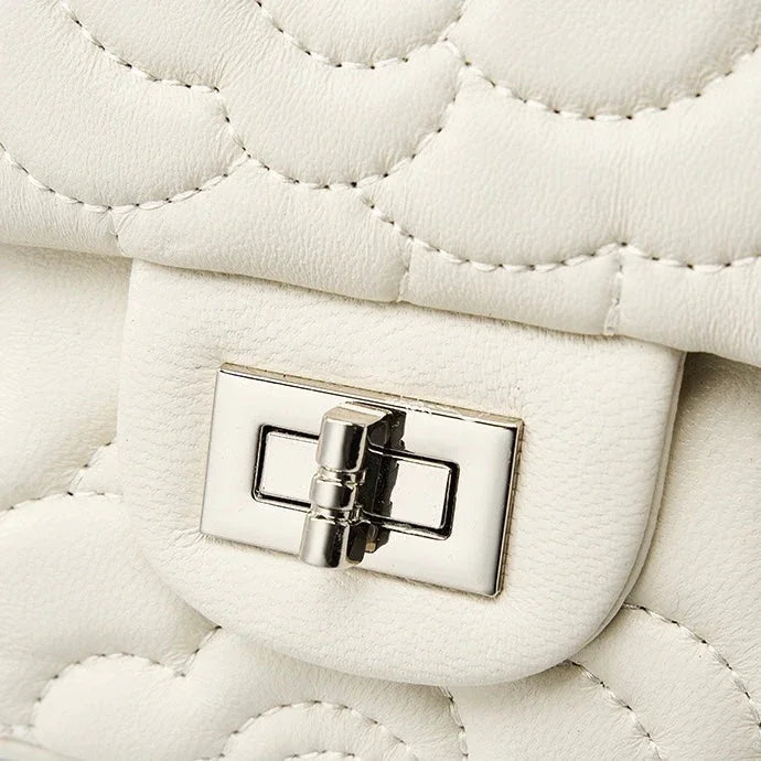 White quilted leather handbag with silver turn-lock clasp detail