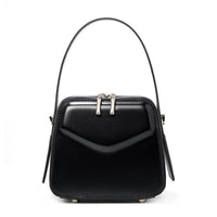 Black square leather handbag with top handle and silver zipper accents on white background