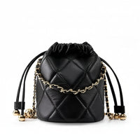 Black quilted leather drawstring bucket bag with gold chain and metallic accents on white background