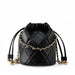 Black quilted leather drawstring bucket bag with gold chain and metallic accents on white background