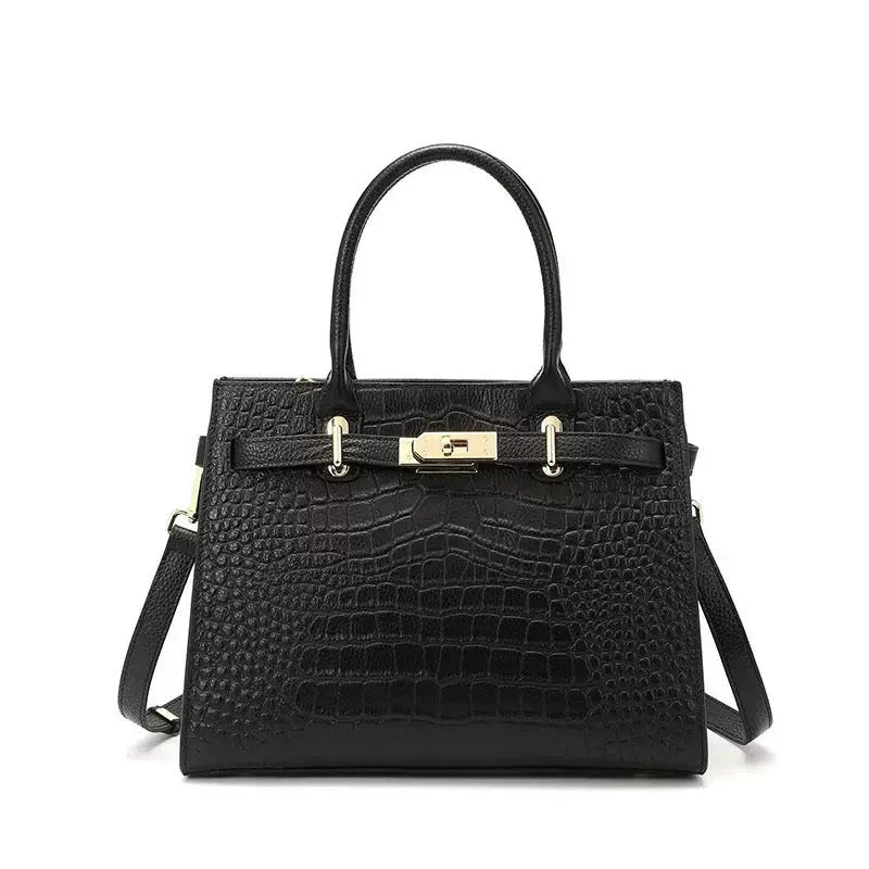 Black crocodile embossed leather handbag with gold hardware and top handles