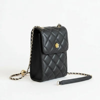 Quilted black leather crossbody purse with gold chain strap on white background