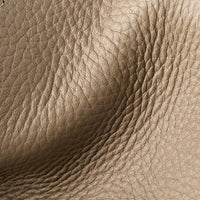 Close-up of textured brown leather surface with natural grain and creases
