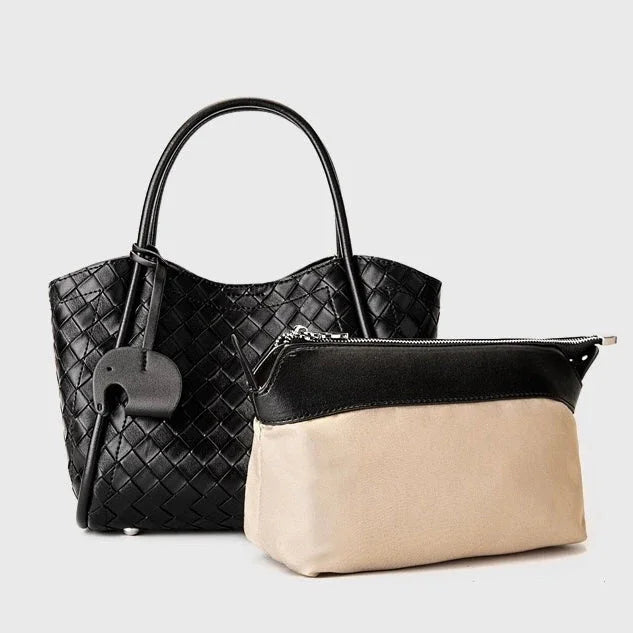 Black woven leather tote bag with handles and beige pouch on a plain background