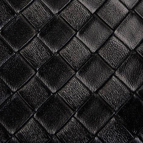 Black woven leather texture with diamond pattern, luxury fashion material close-up