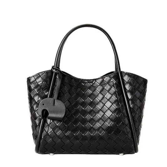 Black woven leather tote bag with dual handles and attached decorative tag