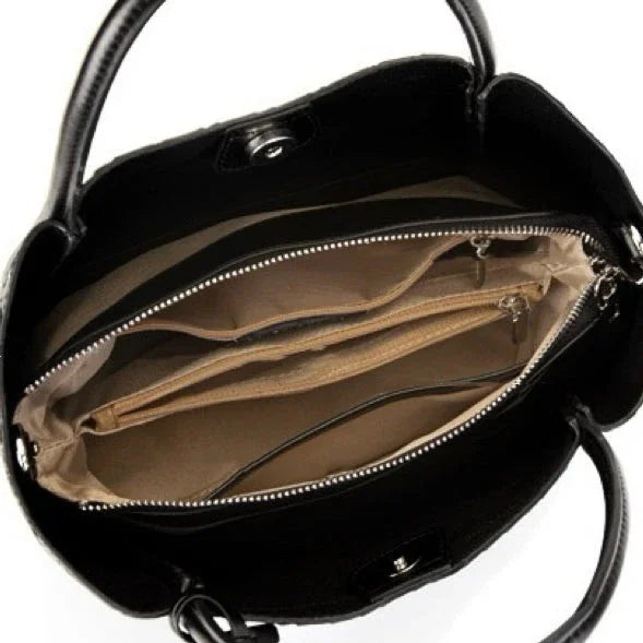 Open black leather handbag with beige interior and multiple compartments