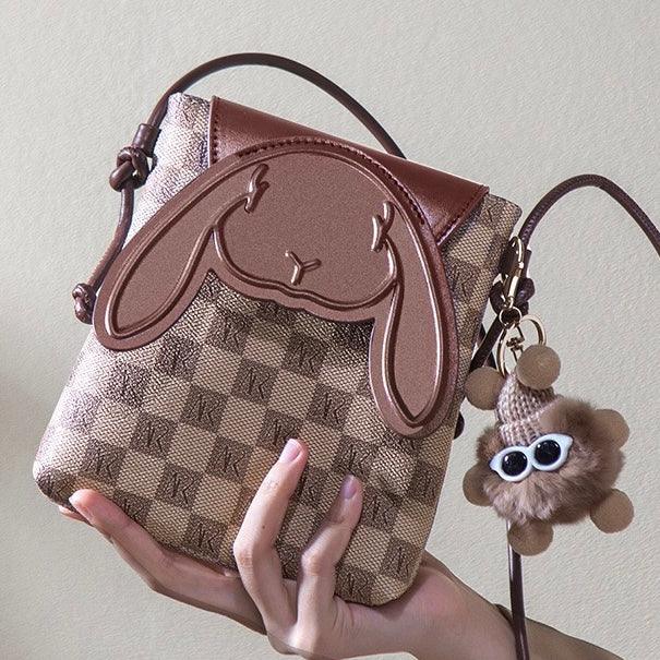 Brown checkered crossbody bag with bunny face design and plush bear keychain