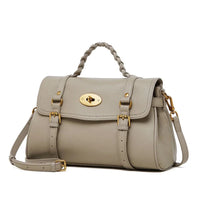 Beige leather satchel handbag with gold hardware and braided top handle on white background