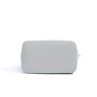 Light gray leather handbag bottom view on white background, minimalist style purse