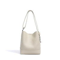 Ivory leather bucket bag with shoulder strap on white background