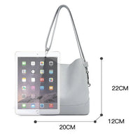 Light gray leather shoulder bag with size measurements and an iPad for scale