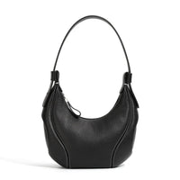 Black leather shoulder bag with curved design and white stitching on white background