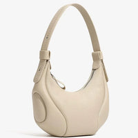 Beige crescent-shaped leather shoulder bag with zipper and textured finish on white background
