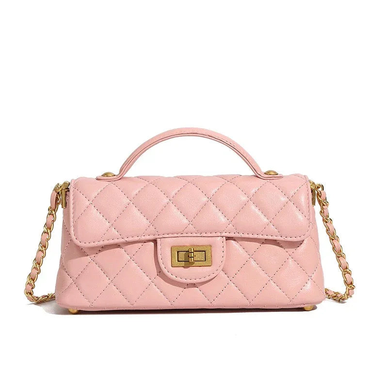 Quilted pink leather handbag with gold chain strap and top handle on white background