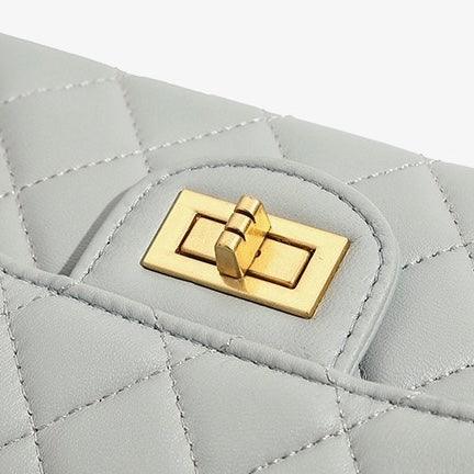 Quilted light grey leather handbag with gold turn-lock closure