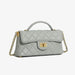 Quilted light gray leather handbag with gold chain strap and turn-lock clasp on white background