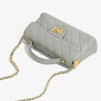 Light grey quilted leather handbag with gold chain strap and turn-lock clasp