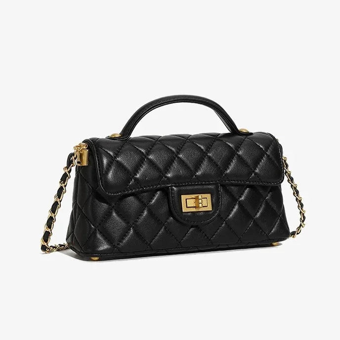 Quilted black leather handbag with gold chain strap and turn-lock closure on white background