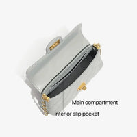 Quilted light gray handbag with gold chain strap, main compartment and interior slip pocket labeled.