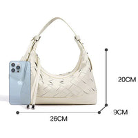 Cream woven leather shoulder bag with handle, next to smartphone, size 26x20x9 cm