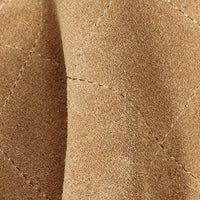 Close-up of tan suede quilted fabric with visible stitching detail