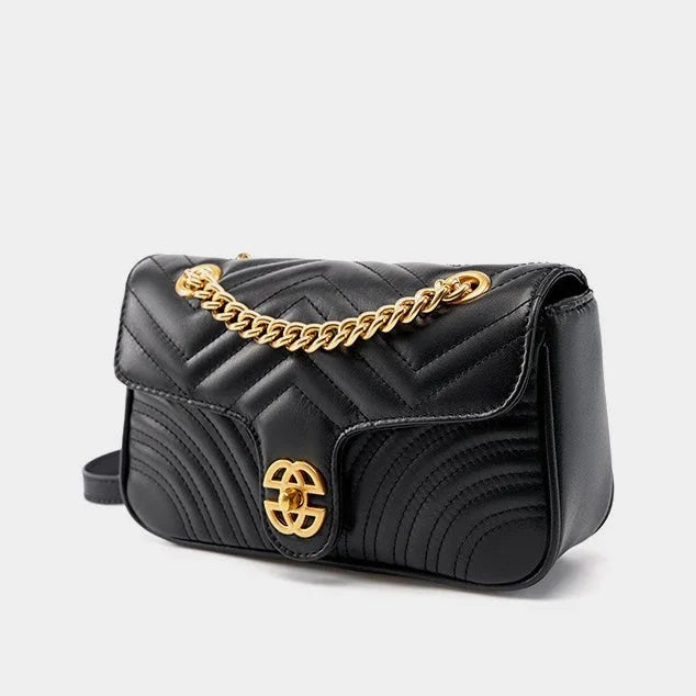 Black quilted leather shoulder bag with gold chain strap and gold clasp, luxury handbag