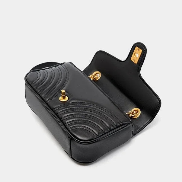 Black leather quilted shoulder bag with gold hardware and open flap