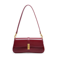 Burgundy leather shoulder bag with gold clasp and strap hardware on white background